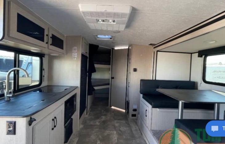 This table folds down into a bed that can support 1 adult comfortably up to 5 ft. 5 inches or 2 small children.