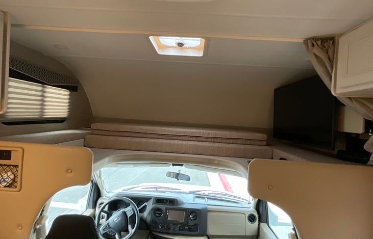Over cab bunk bed with privacy curtain, sleeps two adults comfortably . Bedding included.