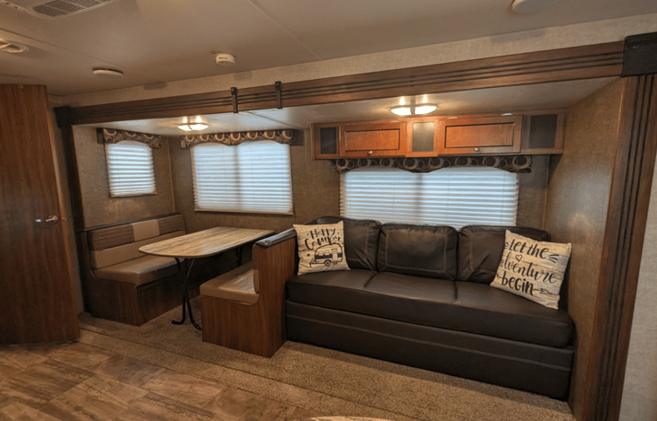 Booth dinette table drops down to make into a bed, will sleep 2. Sofa folds out and will sleep 2.