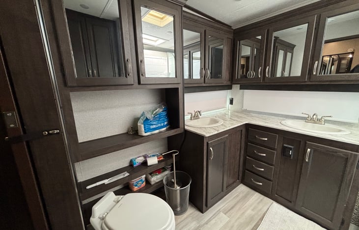 Dual sinks and full size residential toilet.