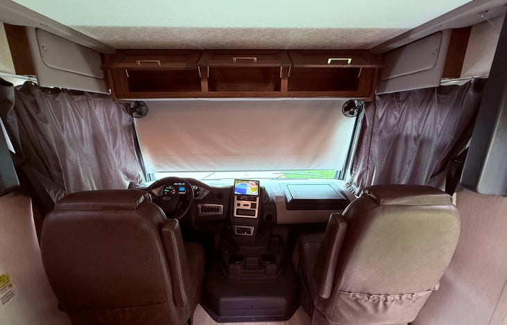 Cab complete with power windshield privacy shade, side window curtains, and overhead storage.  Power drop down cab bunk as well!