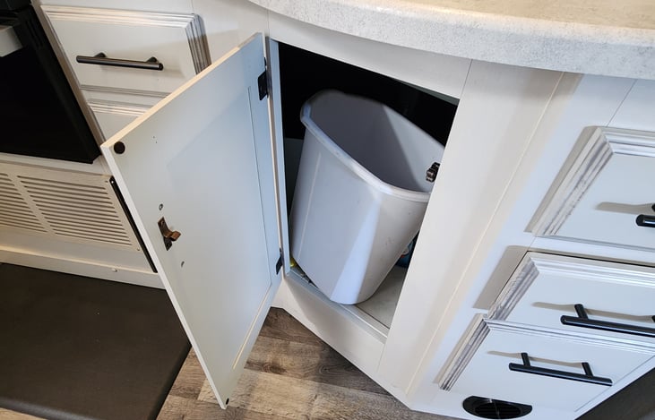 Plenty of cabinet storage area all around (top and bottom, inside and outside of RV). Keep inside trash receptacle out of sight and out of the way, under the kitchen cabinet.