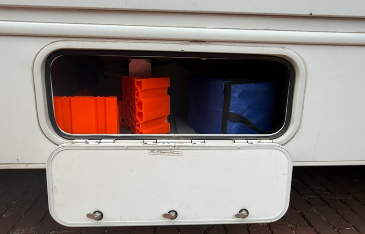 Drivers side compartment carrying the front levelers.