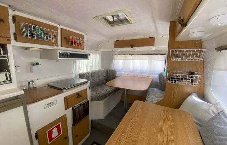 Casita interior dinette/convertible bed view. Just take the post down, set the table on the booth, move cushions down, and use provided linens to set up your sleep area.