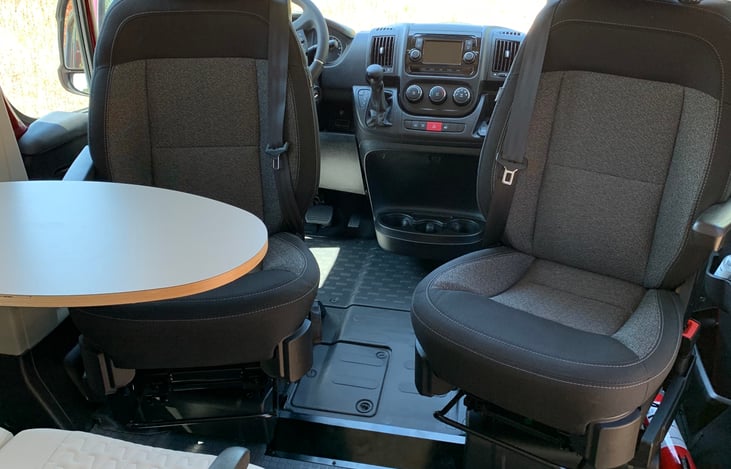 Cab driver's and passenger's chairs swivel around to face rear seats for dining when camping.