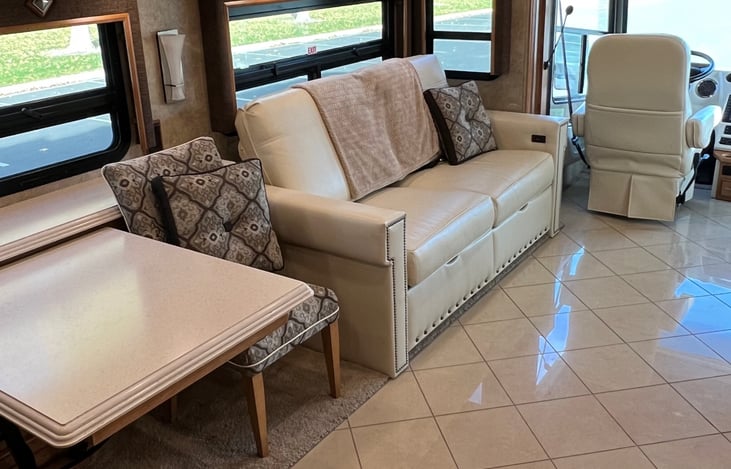 Sofa that converts into a bed and sitting table with chairs.