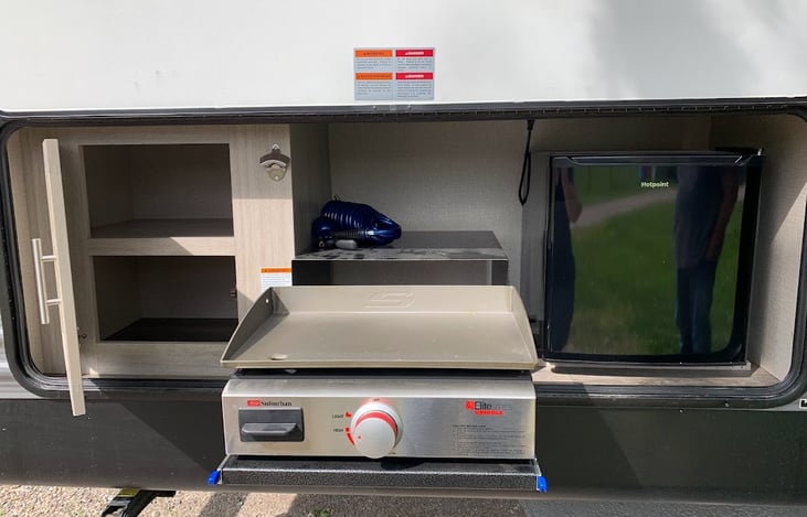 Outside cupboard and grill.