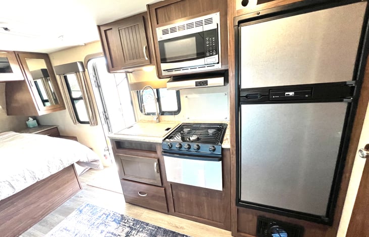 Microwave, 3 burner stove, refrigerator, sink cover for more countertop space