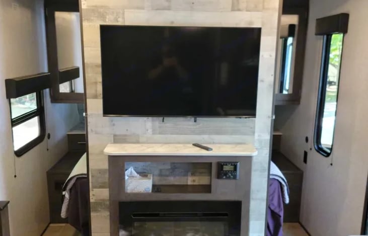 40" HDTV. Stereo with Bluetooth and AUX inputs.  Speakers in ceiling and outside.

Electric fireplace puts out a surprising amount of heat enabling you to save your propane.