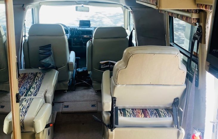 2 captain’s chairs behind the driver and passenger chairs that fold down for added storage or an additional bed.