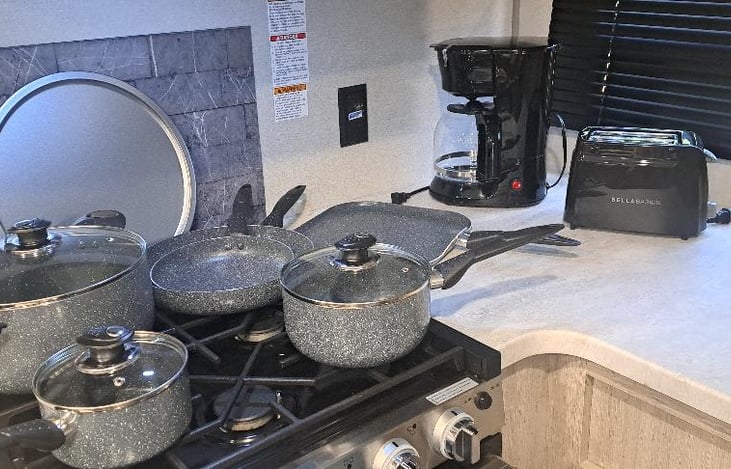 Cooking pots/pans/ toaster/coffee maker.
Also includes silverware, cooking utensils, bowls
plates, cups (both coffee cups and drinking glasses) 
BBQ utensils,