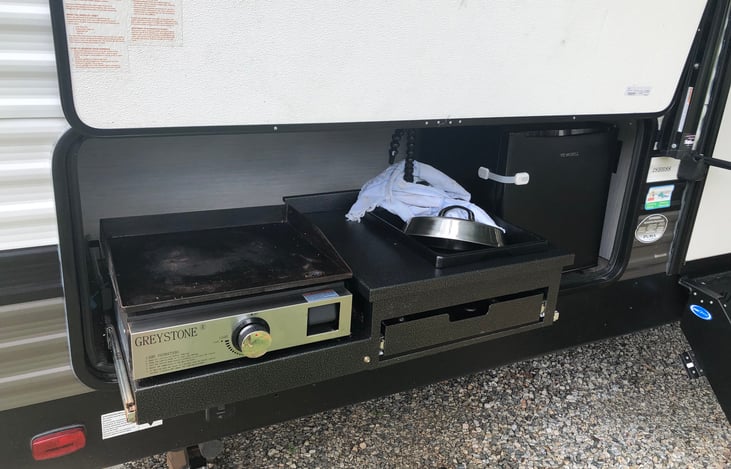 outdoor kitchen with Blackstone sink and frig
