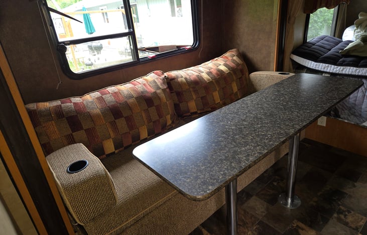 If I am in a campground, I eat at the picnic table outside most of the time.  I use the table as kitchen counter top as there is precious little around the stove and sink.