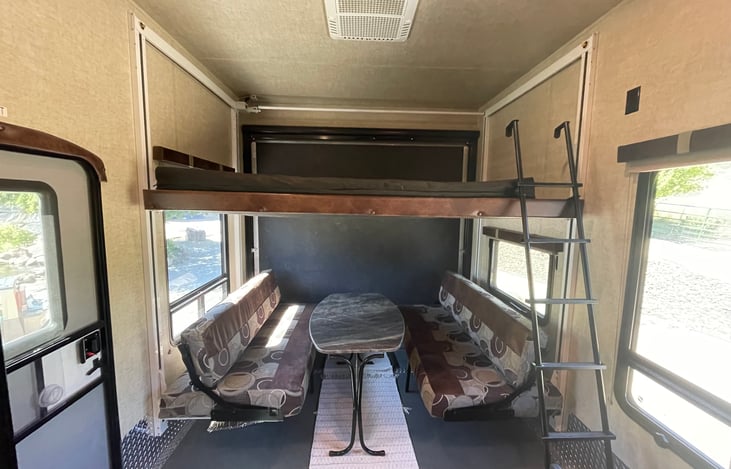 Upper bunk lowered. Dining for 6 adults set up.