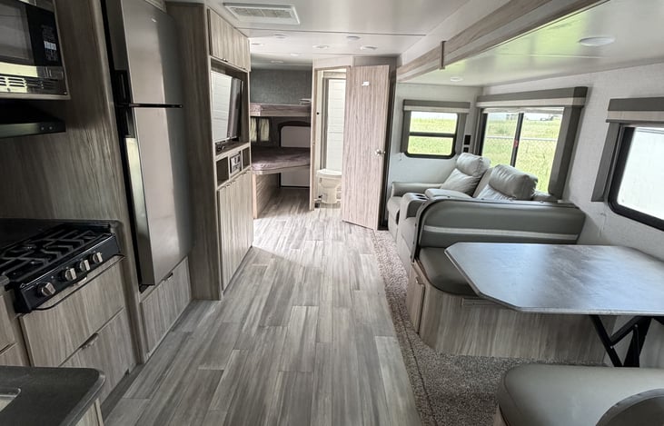 View from master, showing the dinette, theater seating, bunks, bathroom, and kitchen galley