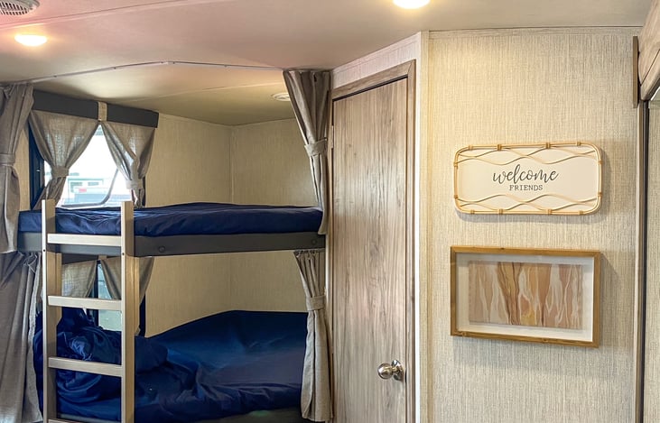 Back of camper has the full size bunk beds and the bathroom