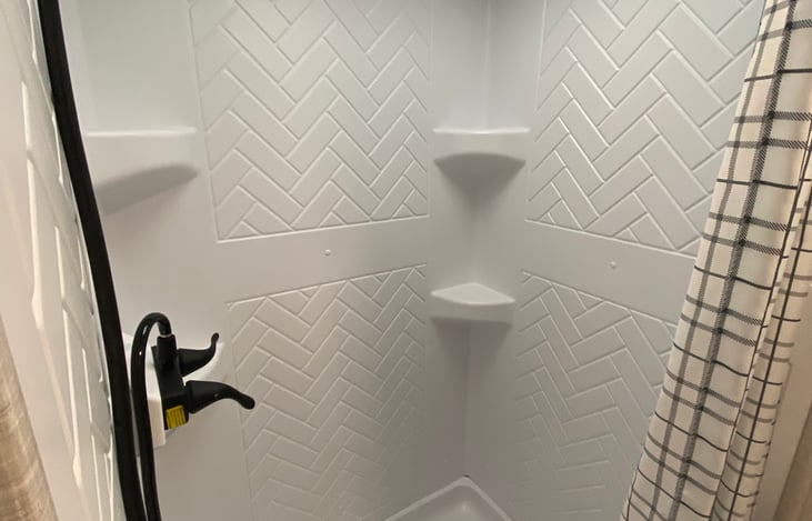 Spacious shower with inline on demand hot water.