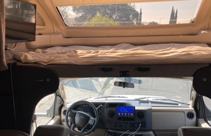 Loft bed view with 30" smart tv and electric screen sky window.