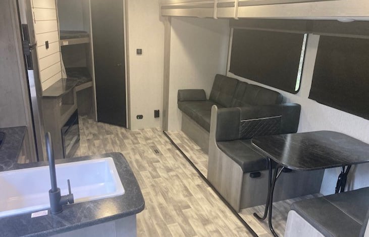 Spacious living area with sofa bed and dinette bed.