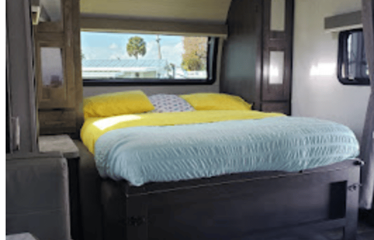 Murphy Bed in sleeping position.  Fabulous front wind let's natural light pour into the RV.