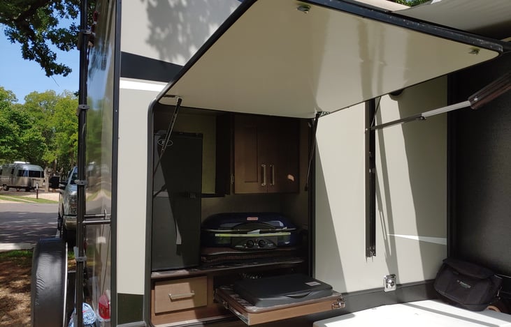 Outdoor kitchen, refrigerator, propane cooktop burner.