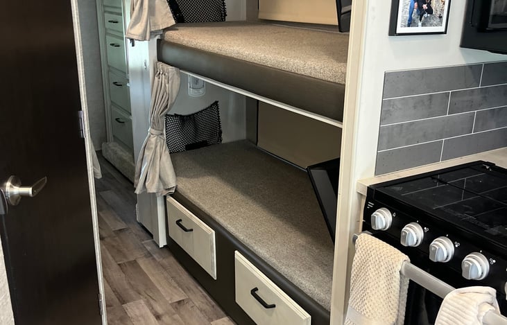 Bunk beds with privacy curtains and TV's.