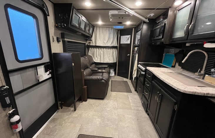 Interior looking from front to rear with bunk bed curtains closed