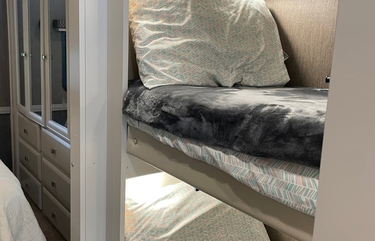 Bunkbeds! Kids get their own bed room with fun barn doors. Each bed includes lighting, electrical plugs and a TV.