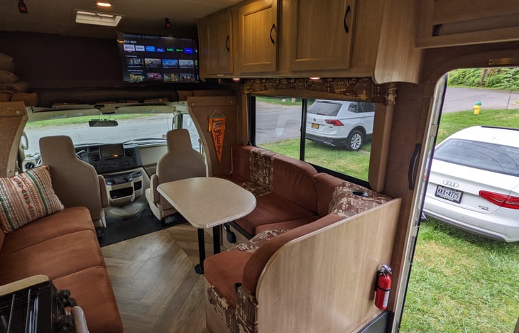 Dinette with seating for 4. Converts to bed (1 adult, 2 kids, comfortably). Extra seat pulls out at front. 3 seatbelts (one child seat anchor). Storage underneath.