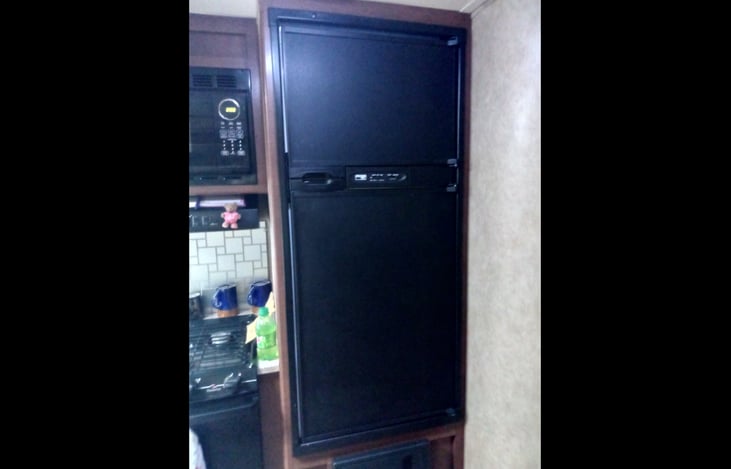 Large fridge with seperate freezer above.