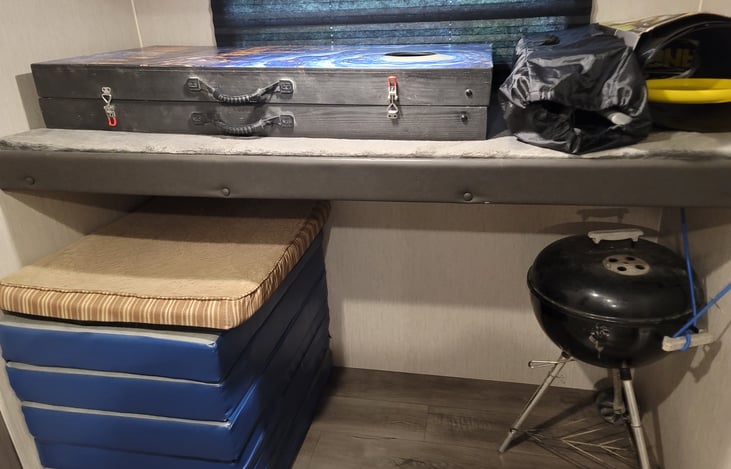 First bunk, mats that also lay on the floor for more sleeping room and grill.