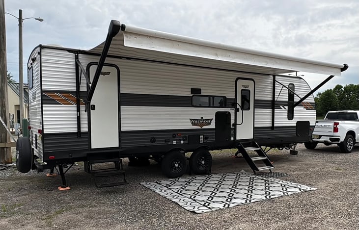 Passenger side view of camper set up to enjoy. All pictured is included with rental.