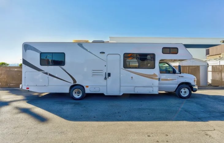 Sleek Thor Majestic 28A exterior set against desert scenery — perfect Las Vegas RV rental for family adventures, Glamis dunes, or Burning Man festivals.