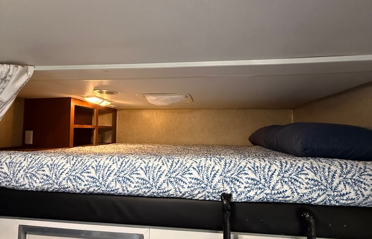 Queen loft, accessible by mobile ladder.