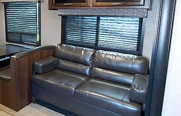 Living area sofa which collapses into a full size bed.