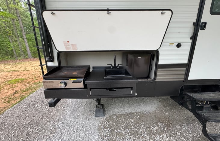Outdoor Cast Iron Grill & Sink combo with mini fridge.