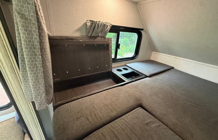 There is a 110v outlet (generator required) tucked in that compartment.