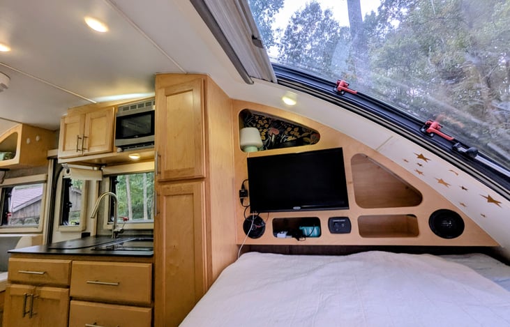 Cozy Queen bed nook with two windows, TV, stereo and storage cubbies will ensure you are comfortable and have everything you need for some rest and relaxation.