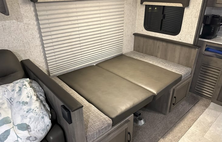 Kitchenette converts into youth bed.