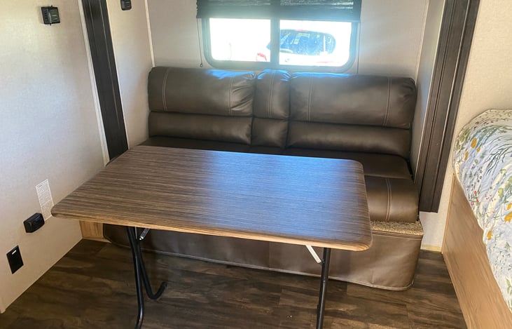 DINING TABLE IS REMOVABLE, AND 2ND DINNG TABLE STORED IN PASS THRU.