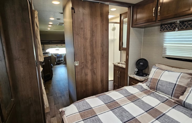 Master bedroom with doors for privacy, closet and underbed storage.