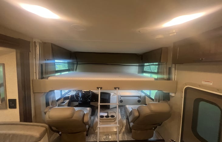 Full Size bed over drivers area.