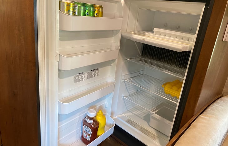 The 8 cu ft. refrigerator is surprisingly spacious.  We easily fit 3-4 days of food, for our family of 4 with room to spare.  There's also plenty of room to store dry goods in the overhead cabinets.