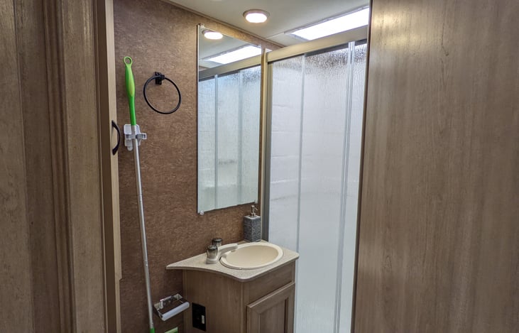 Full bathroom with toilet & shower.