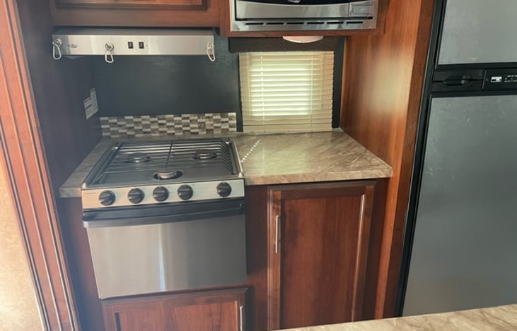 Kitchen: stove, microwave and refrigerator.