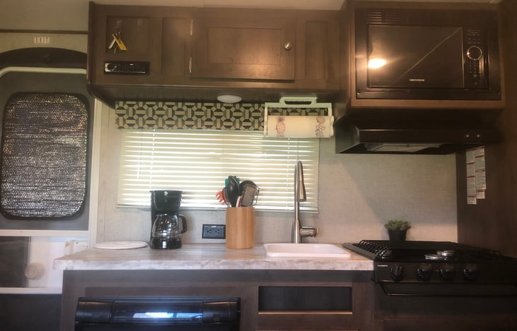 Sitting at dinette table looking at kitchen.  Entrance door to the left