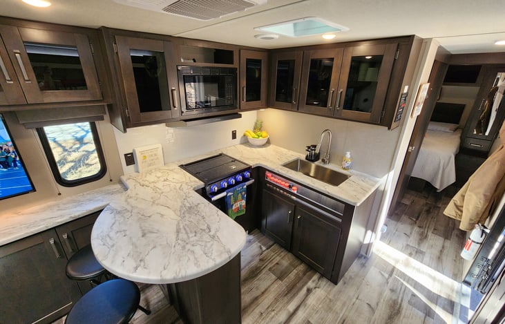 Large kitchen with a 3 burner stove and oven so you can cook almost any meal.