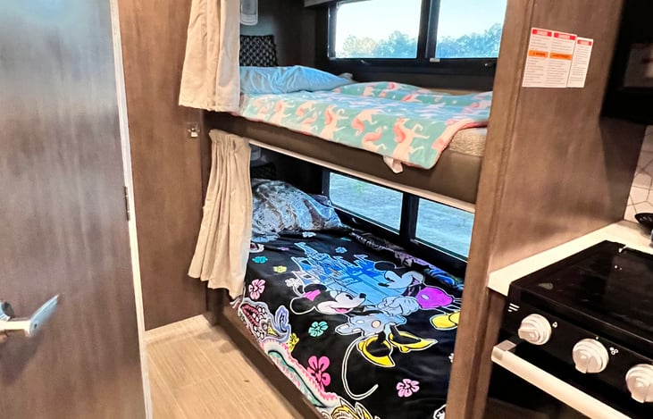 The bunk beds are in their own little alcove, with large windows.