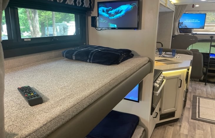 Top bunk looking back towards the kitchen and into front drivers cab.