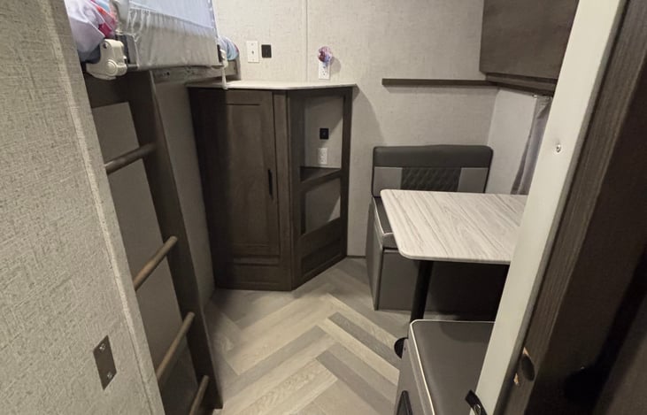 Back bunkhouse with a convertible dinette and murphy bed above.